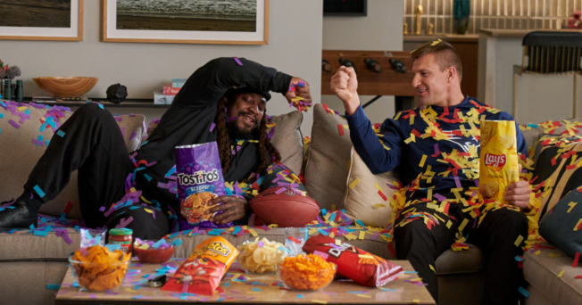 Marshawn Lynch and Rob Gronkowski bump fists during a Frito-Lay commercial