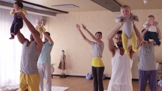 An American woman takes a yoga class with Swedish men and their babies.